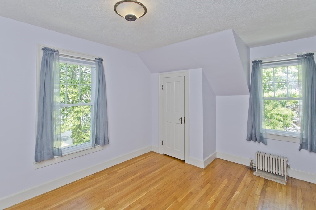144 Pasco Road Springfield, MA 01151 - Photo 22 of 42 a view of an empty room with wooden floor and a window