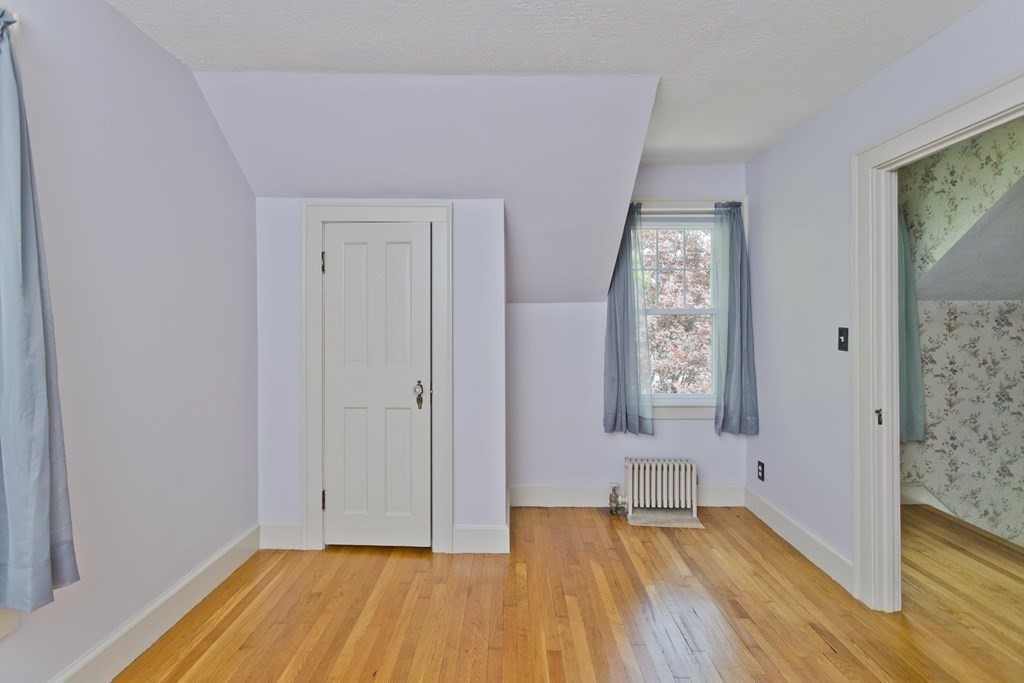 144 Pasco Road Springfield, MA 01151 - Photo 23 of 42 a view of an empty room with wooden floor and a window