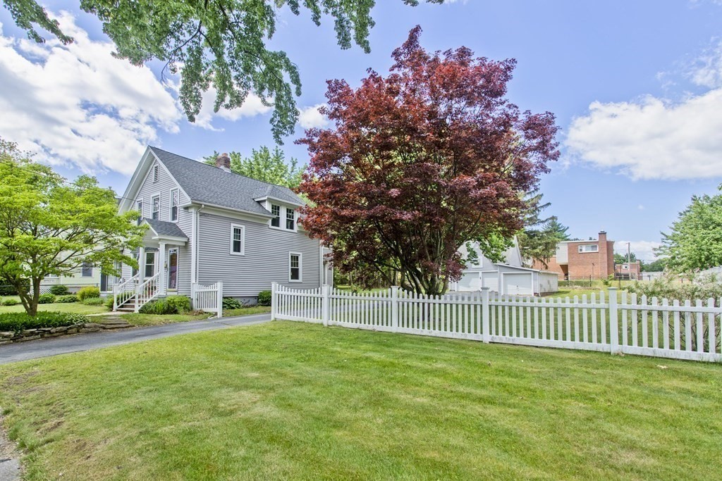 144 Pasco Road Springfield, MA 01151 - Photo 38 of 42 a view of a house with a small yard and a large tree