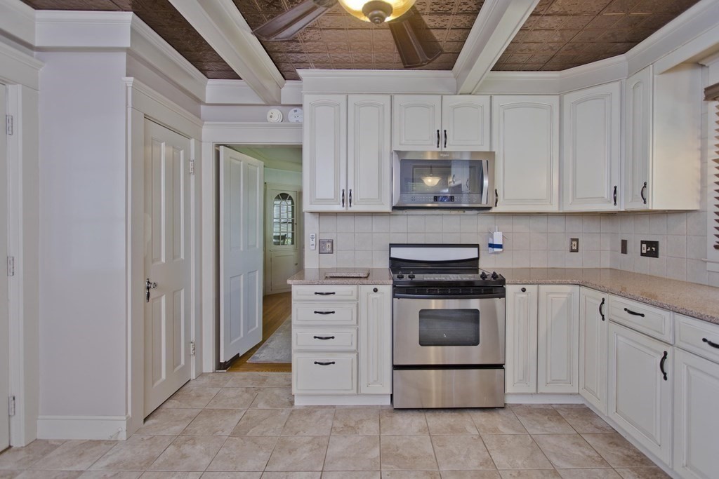 144 Pasco Road Springfield, MA 01151 - Photo 6 of 42 a kitchen with stainless steel appliances granite countertop a stove and a refrigerator