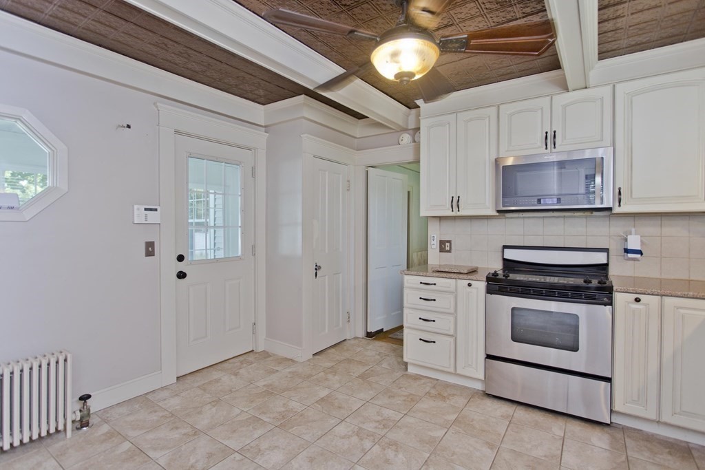 144 Pasco Road Springfield, MA 01151 - Photo 10 of 42 a kitchen with stainless steel appliances white cabinets and a stove