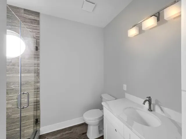 a view of a closet with wooden floor
