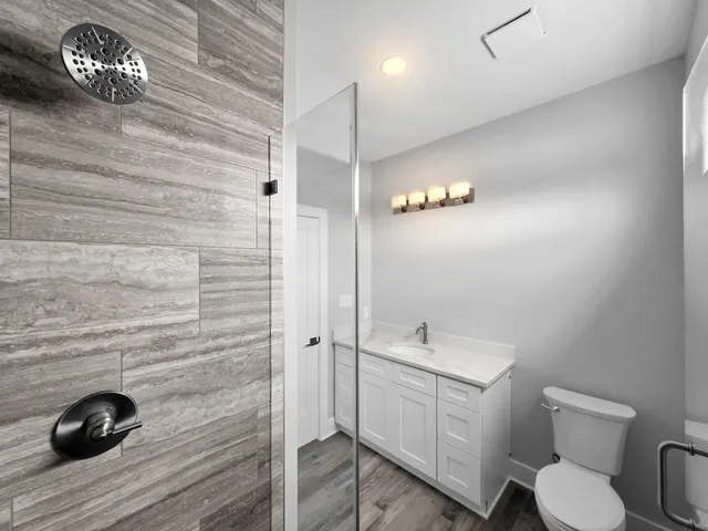 a bathroom with a toilet a sink and mirror