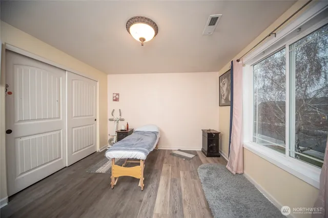 a spacious bedroom with a bed and a cabinets