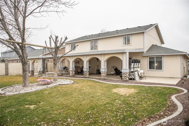 a front view of a house with swimming pool and porch