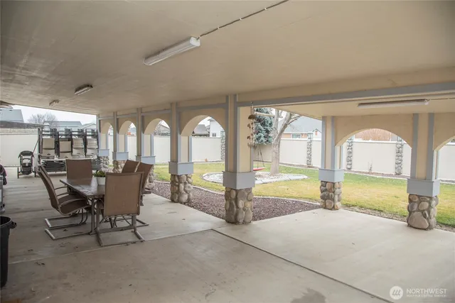 a view of a dining room with furniture a chandelier and wooden floor