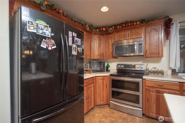 a kitchen with kitchen island granite countertop a sink stove and cabinets