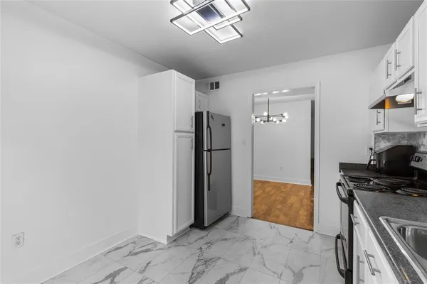 a view of a hallway with workspace and a window