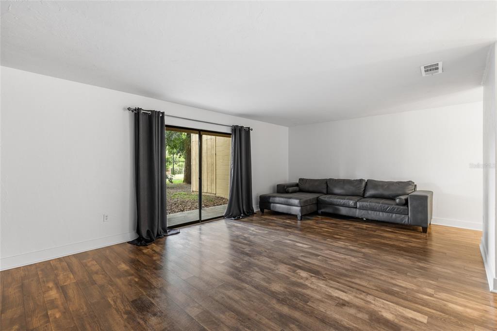 507 Northwest 39th Road, Unit 320 Gainesville, FL 32607 - Photo 15 of 33 a living room with furniture and wooden floor