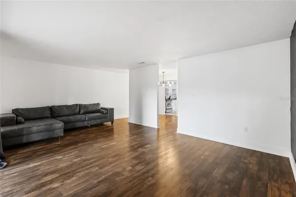 a living room with furniture and a hard wood floor