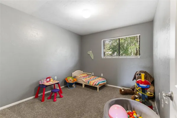 a bedroom with toys and a wooden floor