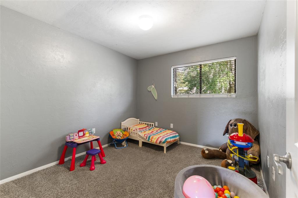 507 Northwest 39th Road, Unit 320 Gainesville, FL 32607 - Photo 20 of 33 a bedroom with toys and a wooden floor