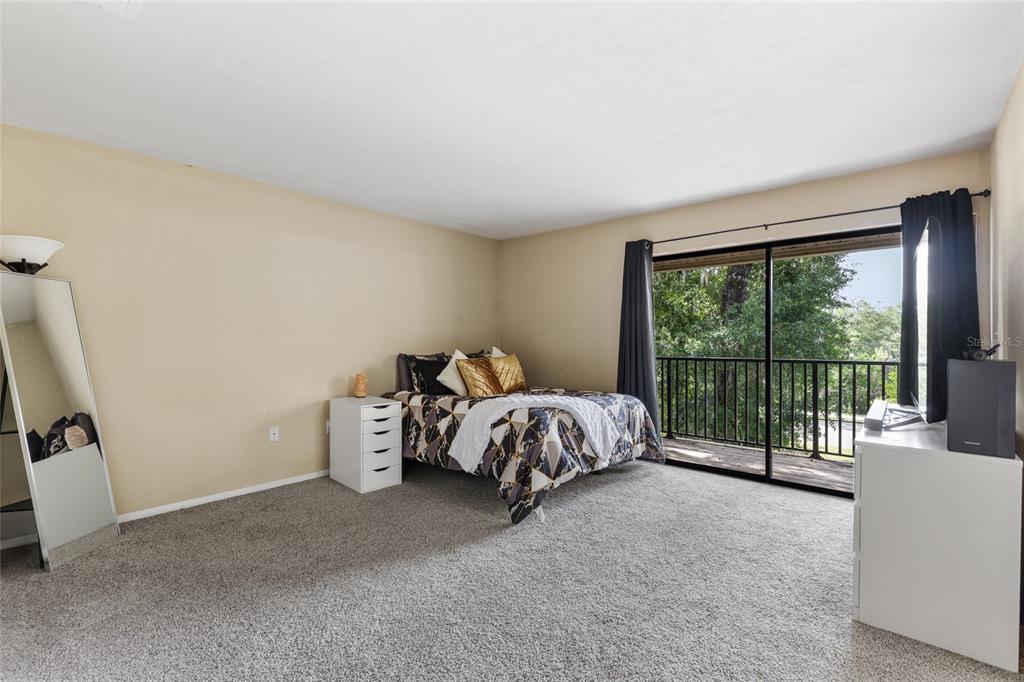 507 Northwest 39th Road, Unit 320 Gainesville, FL 32607 - Photo 23 of 33 a bed sitting in a room next to a window