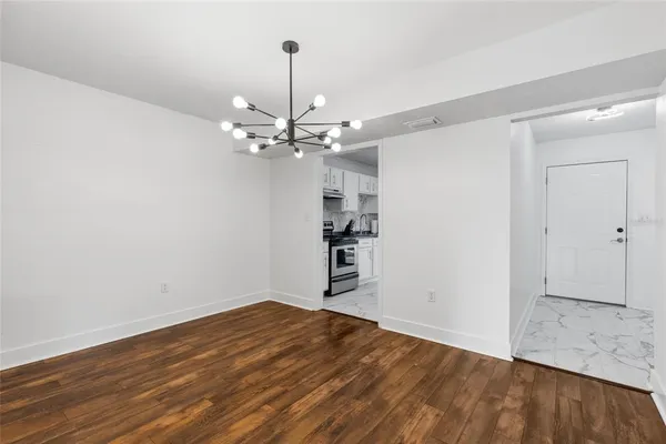a view of a room with wooden floor and closet