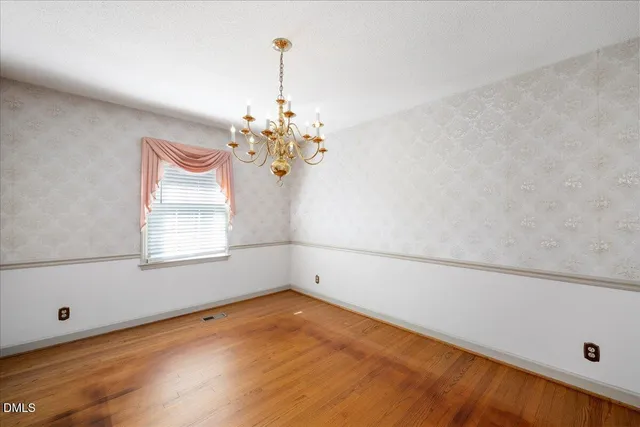 a view of a room with window and wooden floor