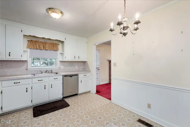 a kitchen that has a lot of cabinets and wooden floor