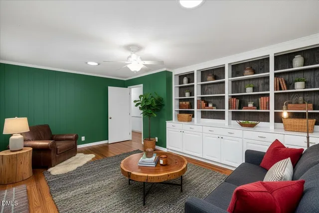a living room with furniture and a potted plant