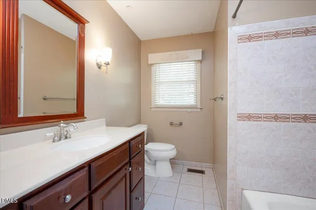 a bathroom with a sink a toilet a shower and a mirror