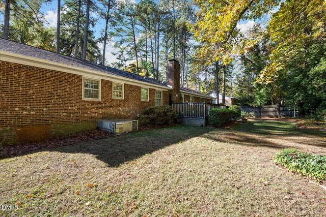 a view of a backyard with large trees