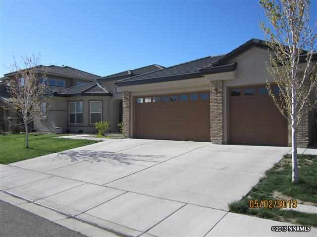 2625 Trail Rider Drive Reno, NV 89521 - Photo 1 of 1 a front view of a house with a yard and garage