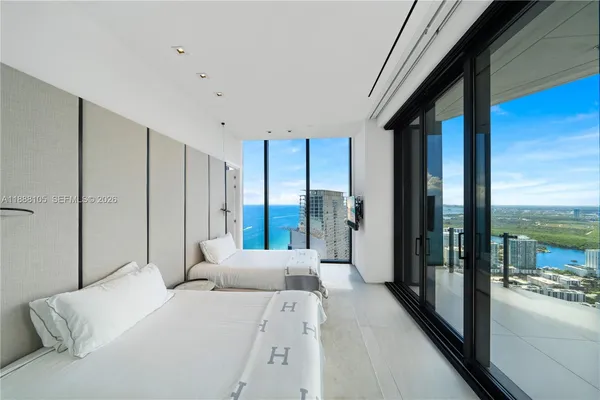 a bedroom with a bed and glass door