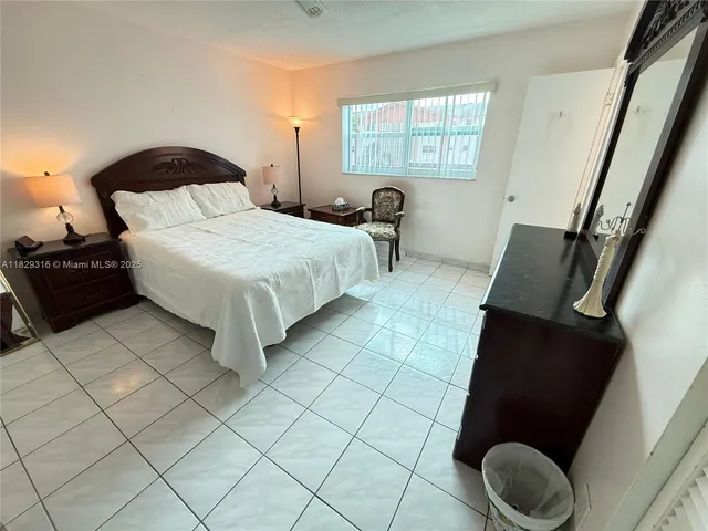 a bathroom with a granite countertop toilet sink and mirror