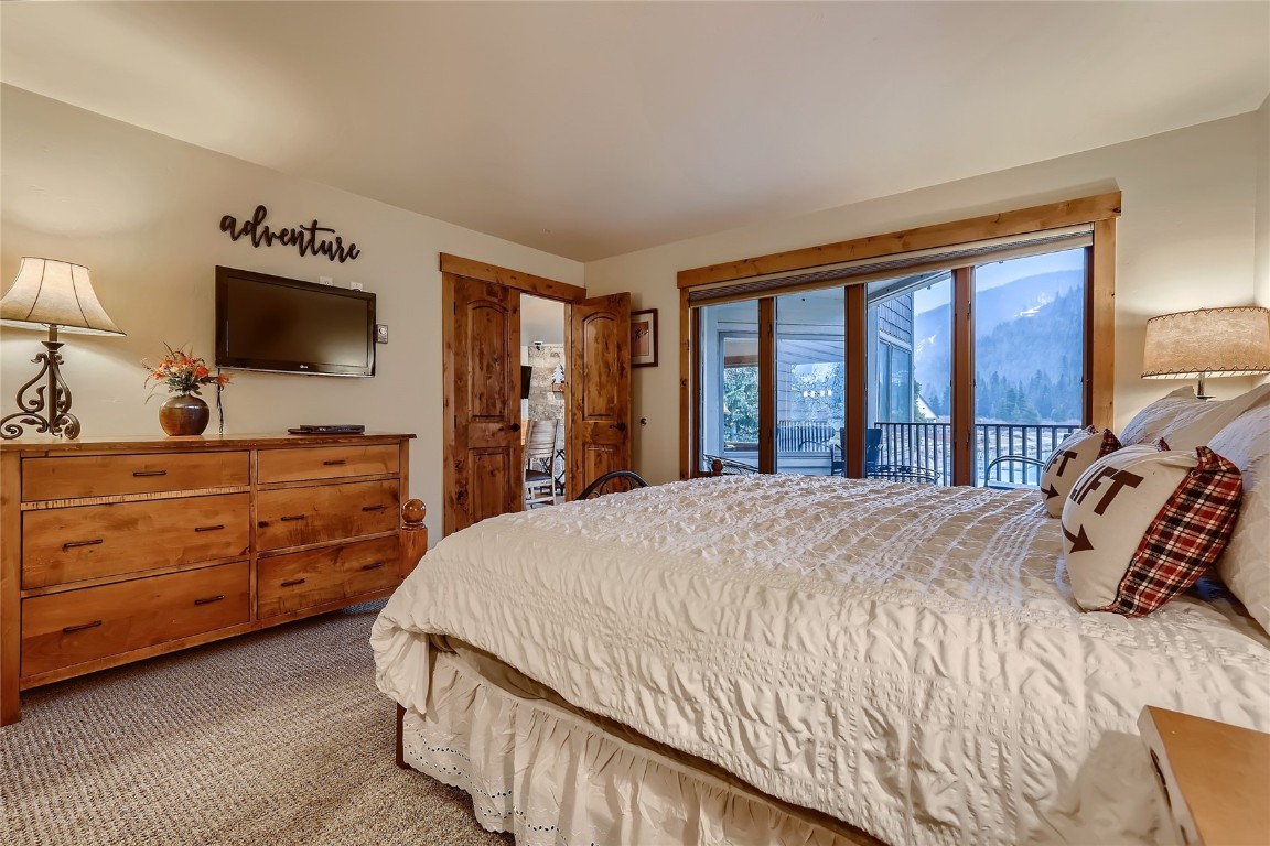 22280 Highway 6, Unit 1709 Keystone, CO 80435 - Photo 14 of 49 Primary bedroom with private balcony access, mountain and lake views
