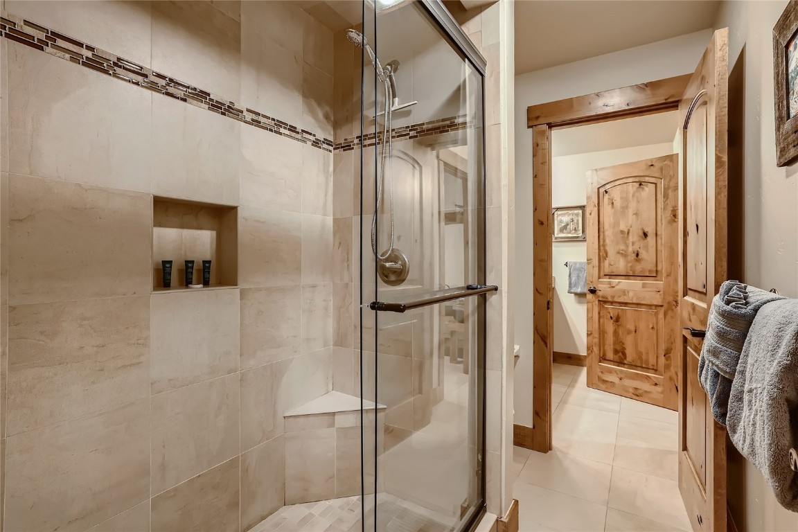 22280 Highway 6, Unit 1709 Keystone, CO 80435 - Photo 16 of 49 Updated walk-in shower featuring decorative tile inlay.