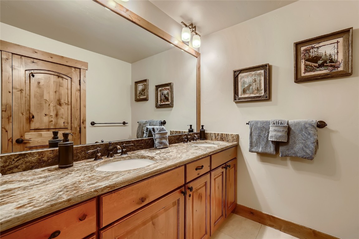22280 Highway 6, Unit 1709 Keystone, CO 80435 - Photo 17 of 49 Bathroom with dual sinks and leathered granite countertops.