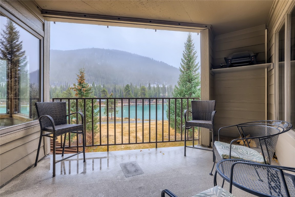 22280 Highway 6, Unit 1709 Keystone, CO 80435 - Photo 19 of 49 Covered balcony overlooking Keystone Lake with mountain and treed viewsideal for relaxing outdoors.