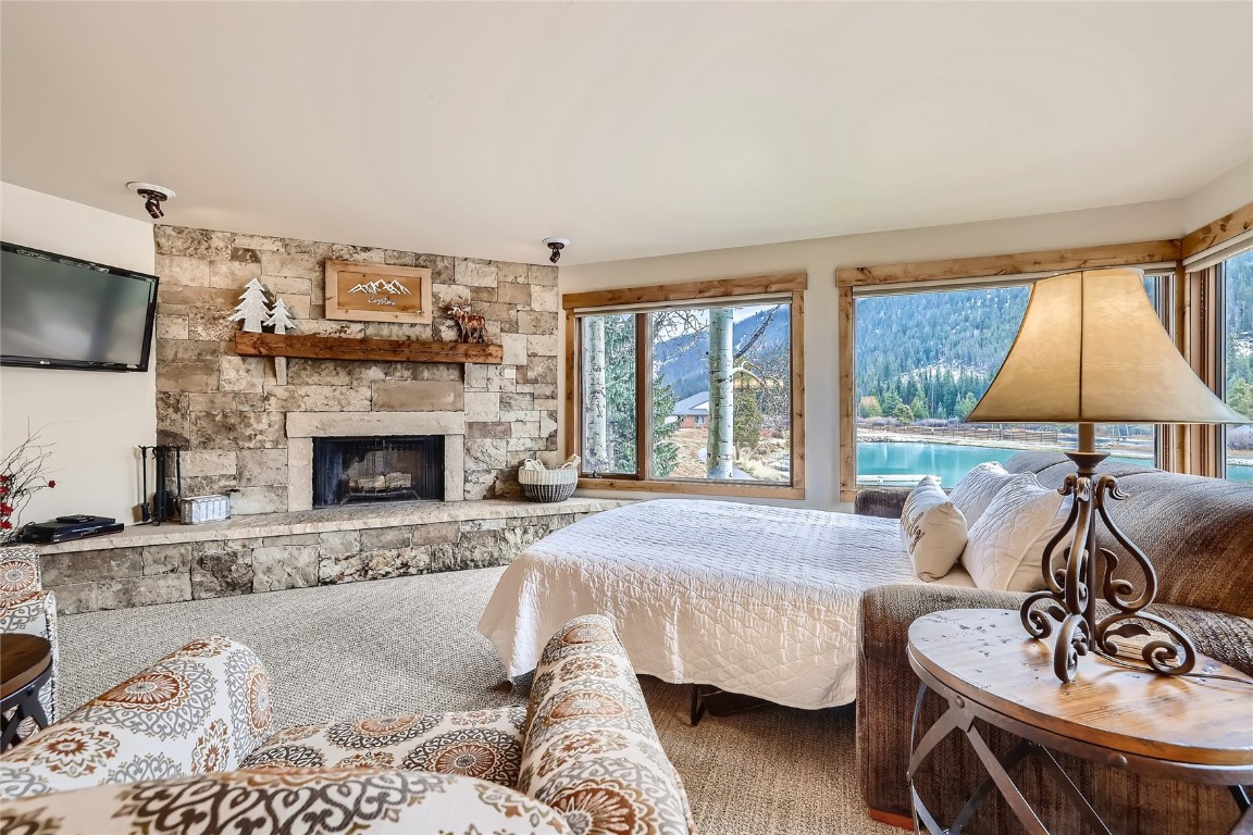 22280 Highway 6, Unit 1709 Keystone, CO 80435 - Photo 7 of 49 Living room with pullout sofa and stone fireplace.
