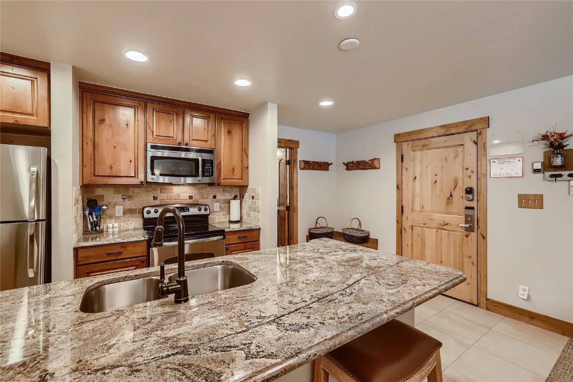 22280 Highway 6, Unit 1709 Keystone, CO 80435 - Photo 10 of 49 Well-appointed kitchen featuring granite countertops, stainless steel appliances, and ample cabinetry.