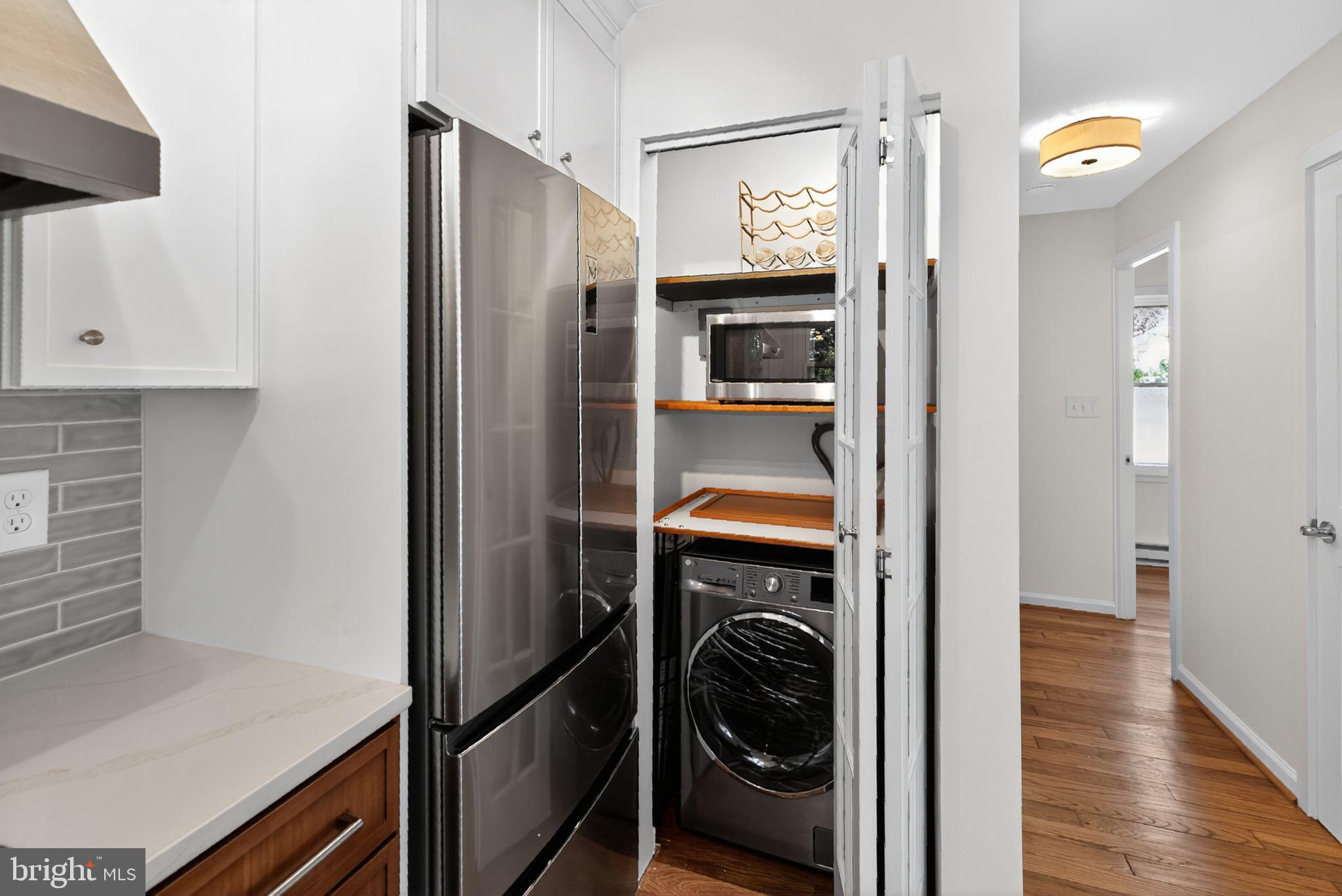 20 Hillside Road Greenbelt, MD 20770 - Photo 11 of 22 a utility room with wooden floor washer and dryer