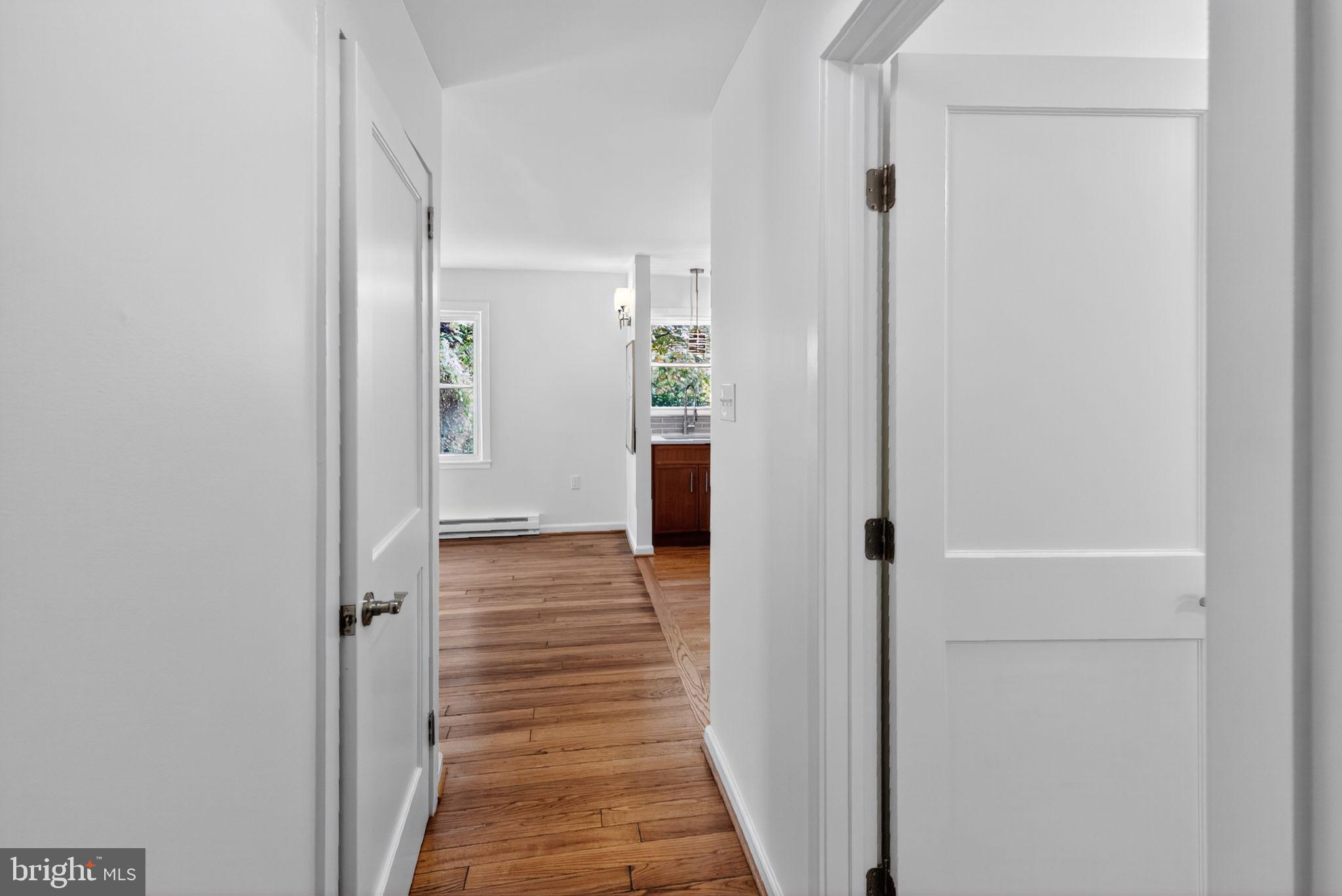 20 Hillside Road Greenbelt, MD 20770 - Photo 13 of 22 a view of a hallway with wooden floor and a bathroom