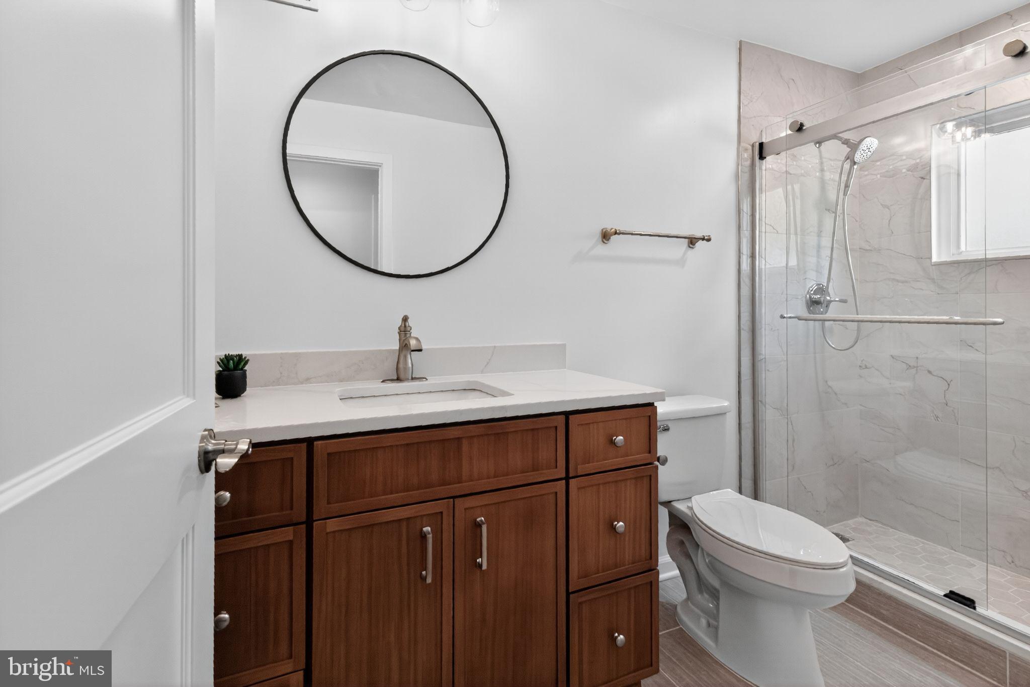 20 Hillside Road Greenbelt, MD 20770 - Photo 14 of 22 a bathroom with a sink mirror toilet and shower