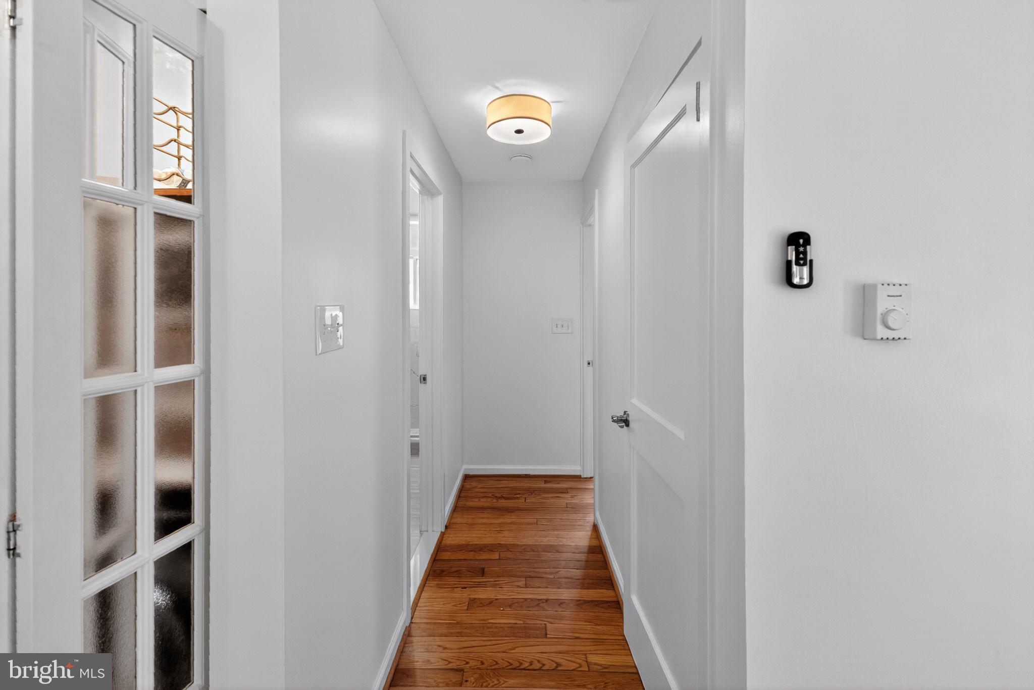 20 Hillside Road Greenbelt, MD 20770 - Photo 18 of 22 a view of a hallway with wooden floor and a bathroom