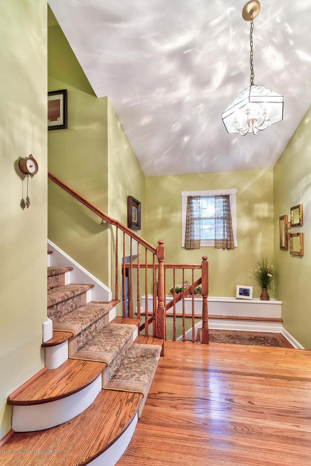 25 Gull Road Middletown, NJ 07748 - Photo 9 of 38 a view of a livingroom with furniture wooden floor staircase and kitchen view