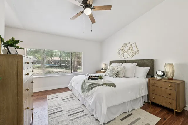 a bedroom with a bed and a window