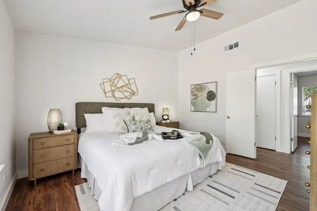 a bedroom with a bed and wooden floor