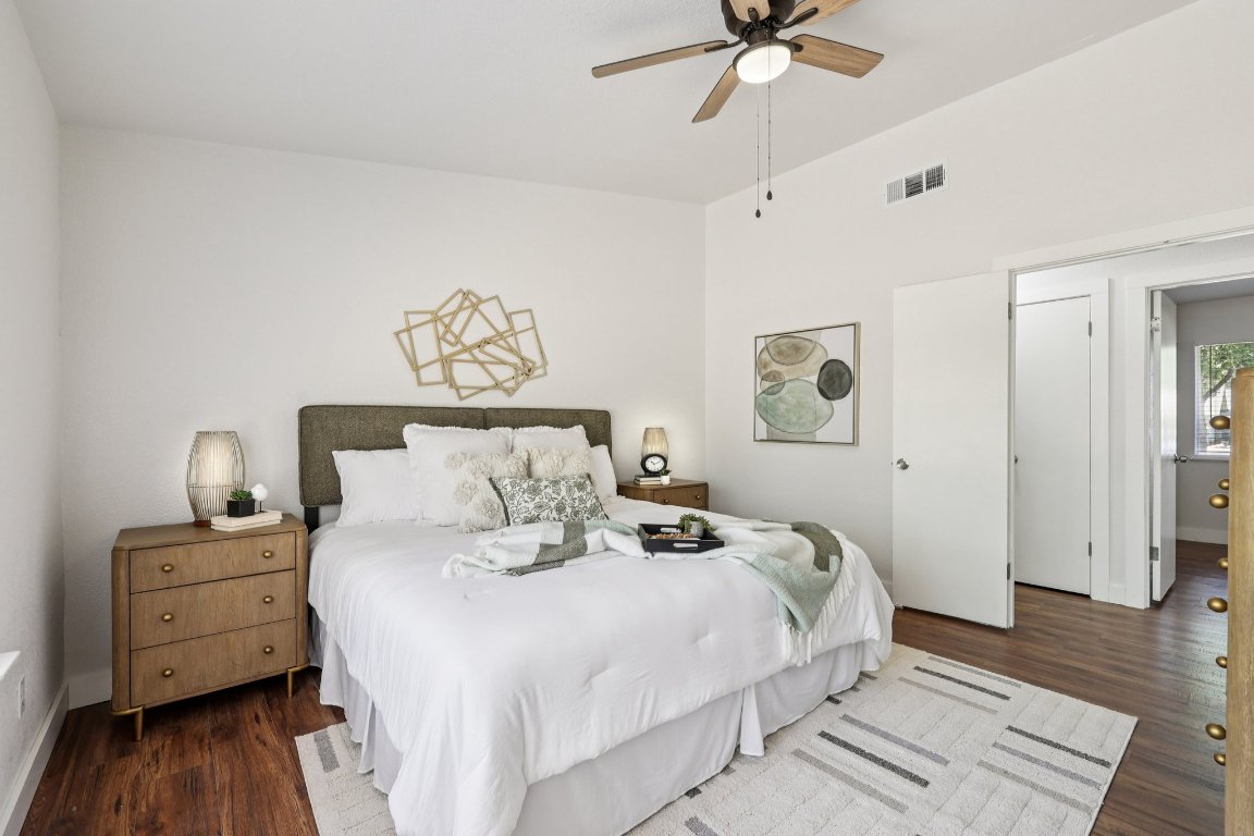 602 Old Stone Road Austin, TX 78745 - Photo 13 of 28 a bedroom with a bed and wooden floor