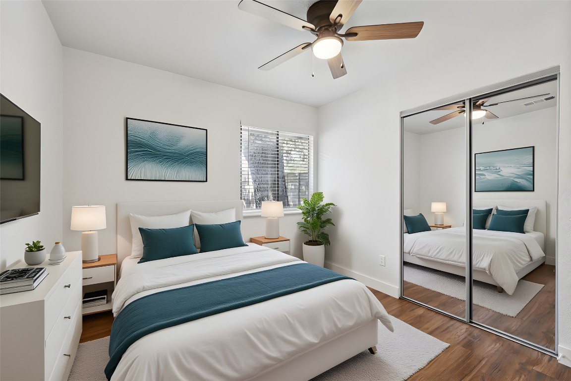 602 Old Stone Road Austin, TX 78745 - Photo 16 of 28 a bedroom with a large bed and a flat screen tv