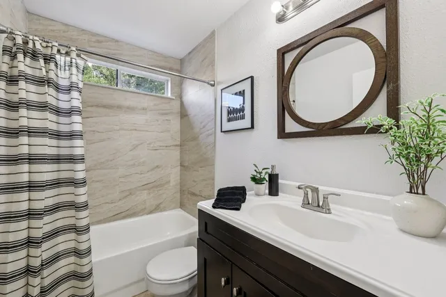 a bathroom with a sink a toilet and a mirror