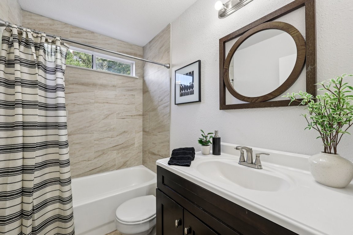 602 Old Stone Road Austin, TX 78745 - Photo 17 of 28 a bathroom with a sink a toilet and a mirror