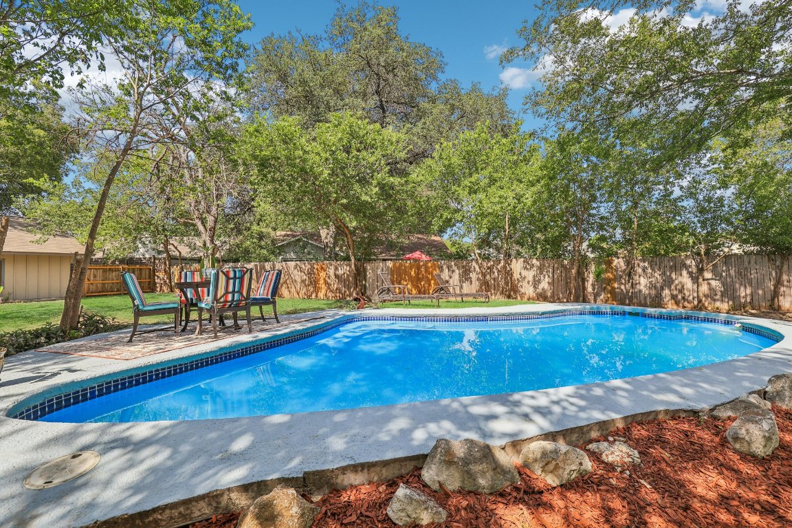 602 Old Stone Road Austin, TX 78745 - Photo 20 of 28 a view of a swimming pool with an outdoor seating