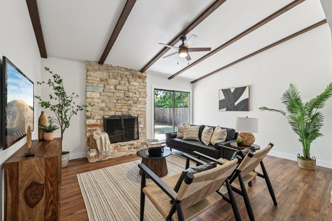 602 Old Stone Road Austin, TX 78745 - Photo 4 of 28 a living room with furniture a flat screen tv and a fireplace