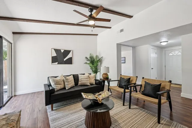 a living room with furniture and wooden floor