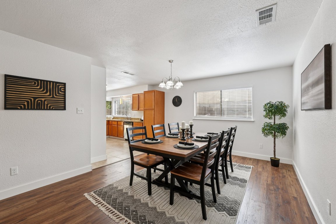 602 Old Stone Road Austin, TX 78745 - Photo 7 of 28 a view of a dining room with furniture and wooden floor