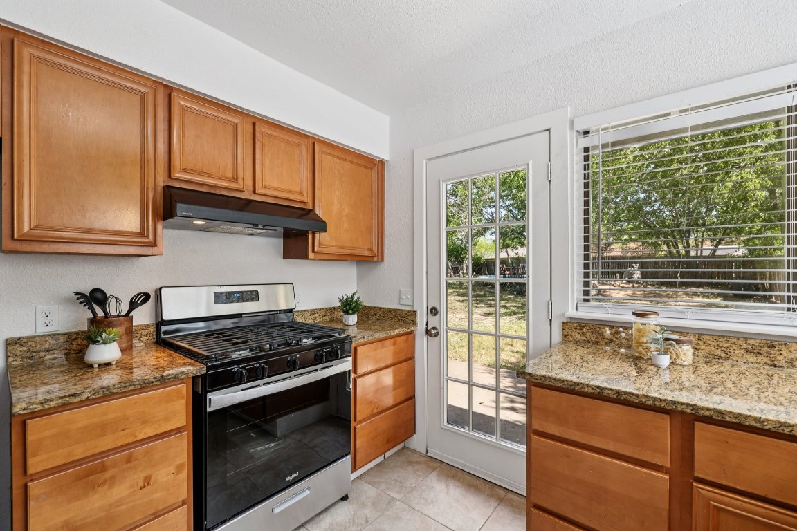 602 Old Stone Road Austin, TX 78745 - Photo 9 of 28 a kitchen with granite countertop a stove and a sink
