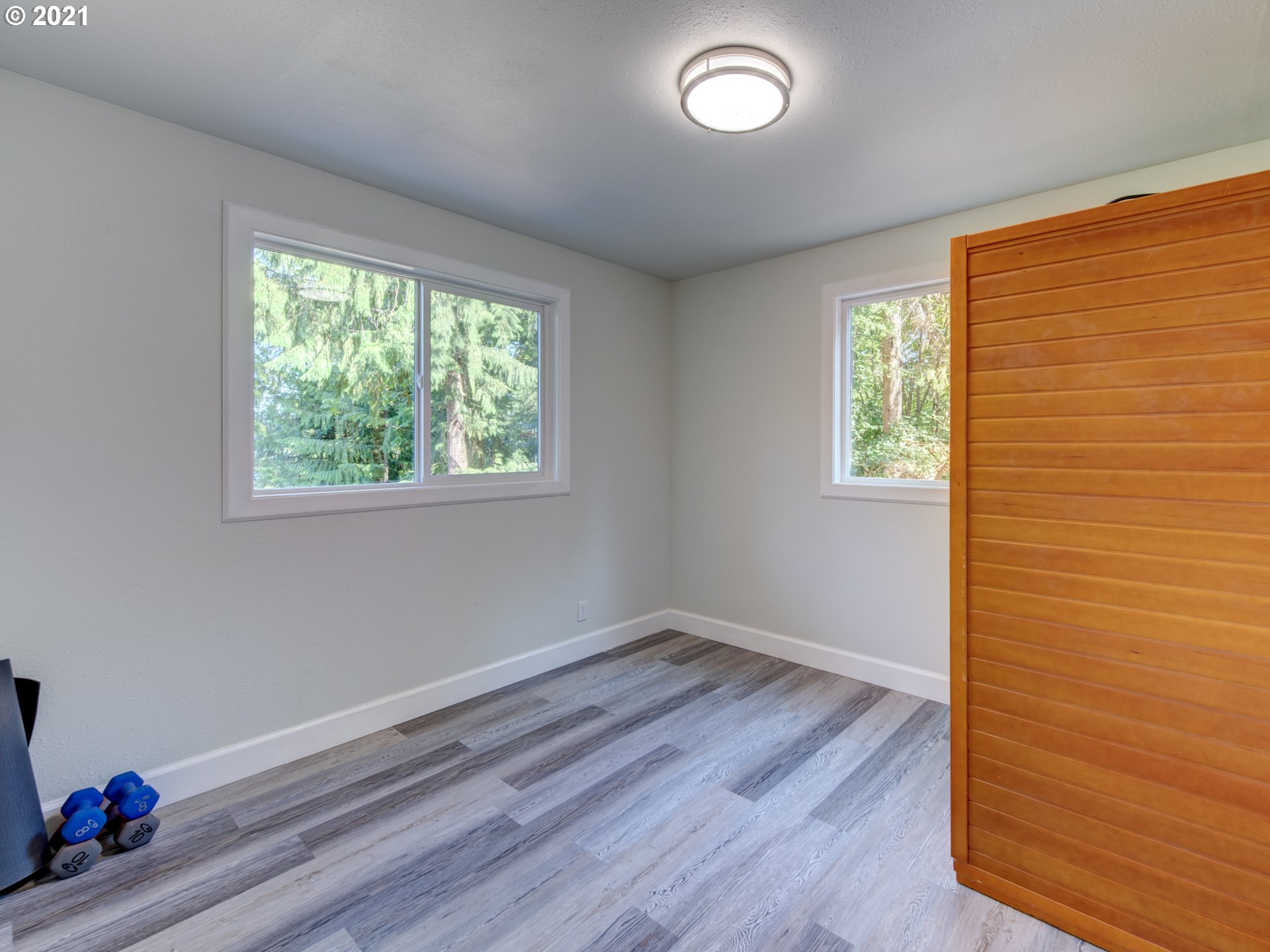 82039 Chickaree Road Lowell, OR 97452 - Photo 21 of 30 a view of an empty room with wooden floor and a window