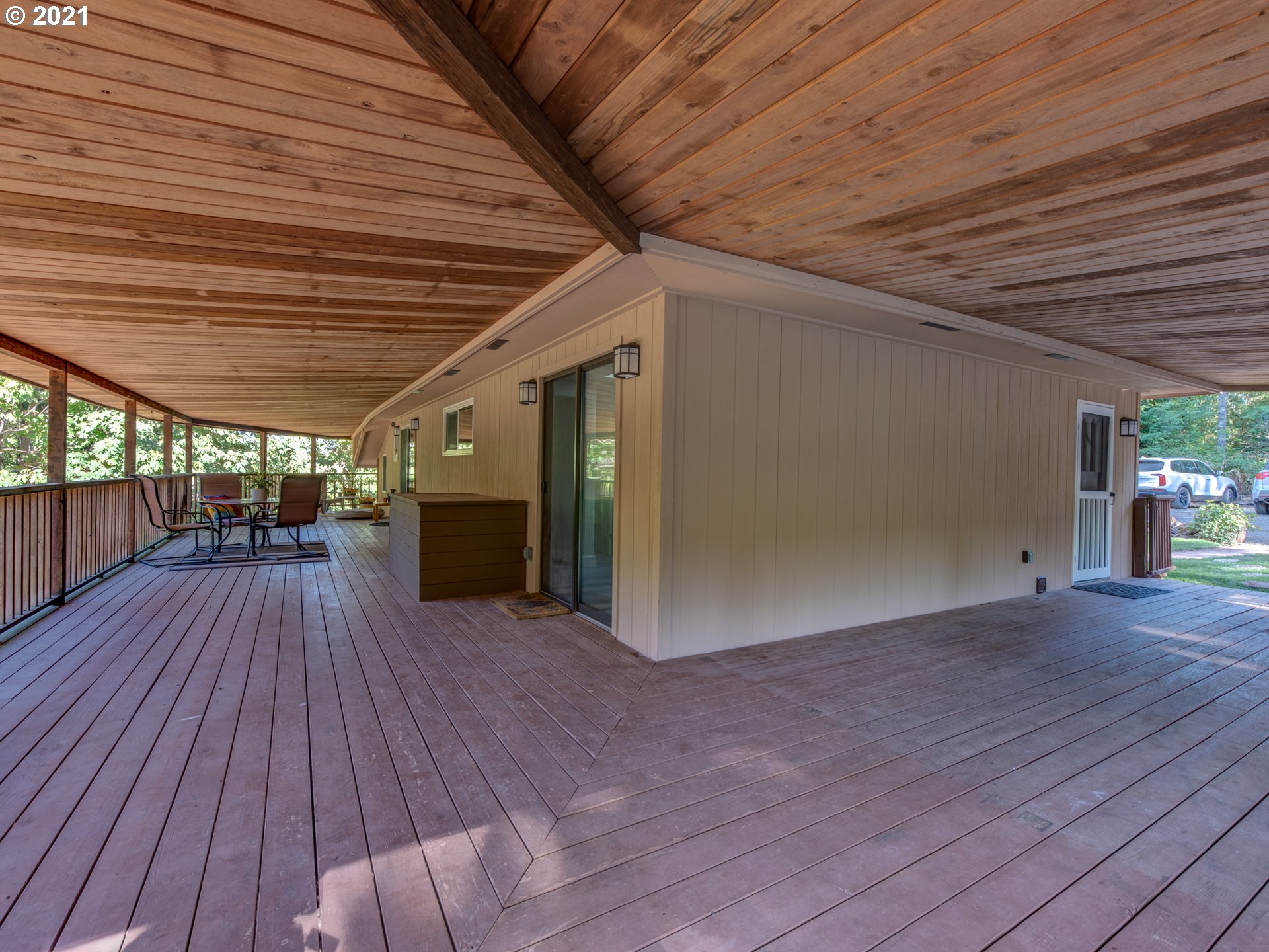 82039 Chickaree Road Lowell, OR 97452 - Photo 22 of 30 a view of backyard with a wooden deck and wooden floor